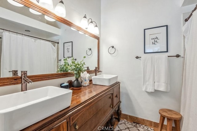 43121 Grizzly Rd, Big Bear Lake, CA 92315 - bathroom featuring tile patterned floors, double vanity, and baseboards
