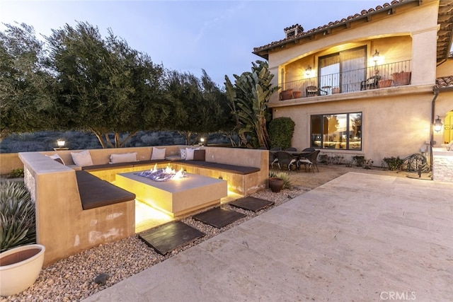 exterior space featuring an outdoor fire pit and a patio