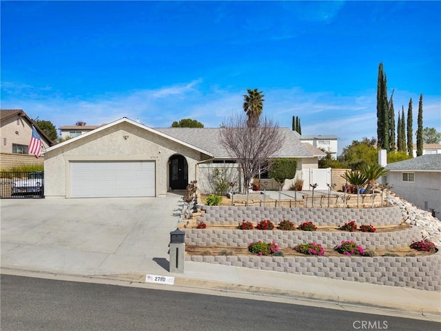 ranch-style house with driveway, an attached garage, fence, and stucco siding