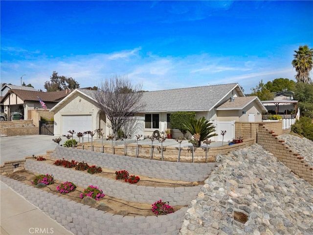 single story home with a garage, driveway, fence, and stucco siding