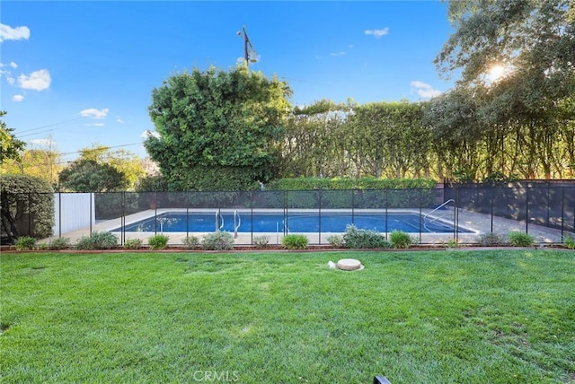 view of swimming pool with fence, a fenced in pool, and a yard