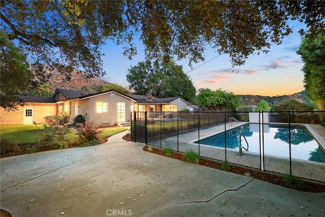 view of pool featuring a fenced in pool, a patio area, fence, and a mountain view