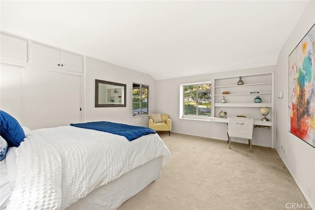 bedroom with light carpet and vaulted ceiling