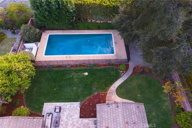 view of pool with a yard