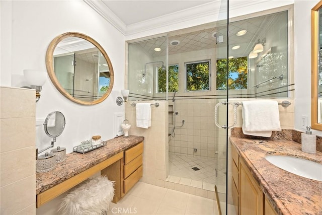 bathroom with tile patterned flooring, a shower stall, crown molding, and vanity