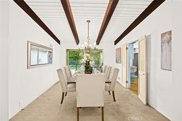 dining room featuring light carpet, lofted ceiling with beams, and a notable chandelier