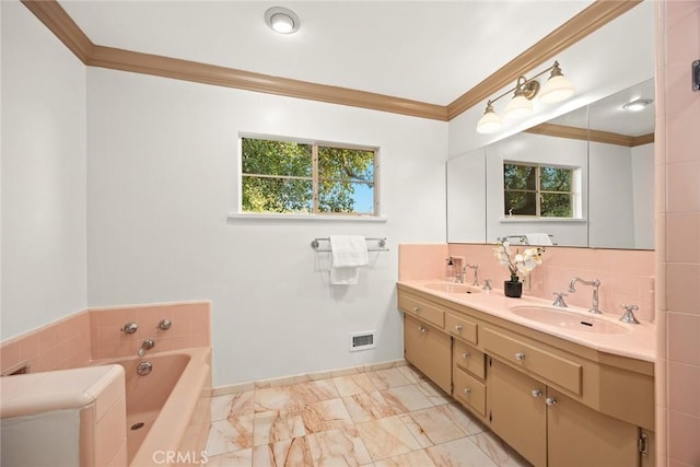 bathroom featuring marble finish floor, ornamental molding, a sink, and visible vents