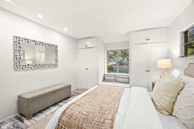 bedroom featuring multiple closets and recessed lighting