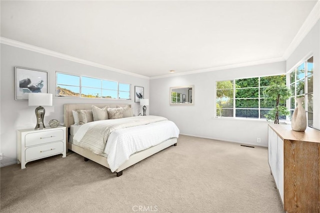 bedroom featuring light colored carpet, crown molding, and multiple windows