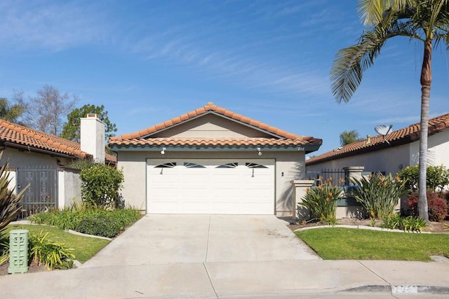 mediterranean / spanish house featuring driveway, a tiled roof, an attached garage, and stucco siding