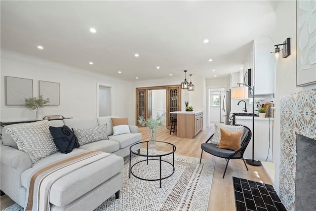 living room with recessed lighting and light wood finished floors