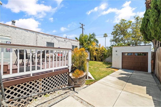 exterior space with an outbuilding, a yard, and a deck