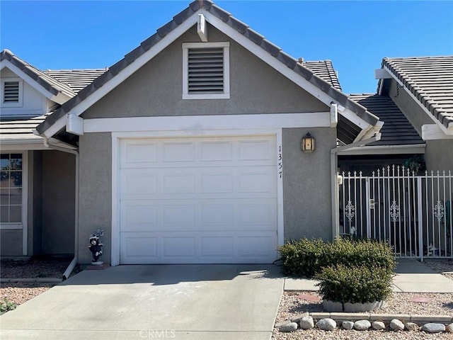 1357 Congress Way, San Jacinto, CA 92583 - view of front of house featuring a garage, concrete driveway, fence, and stucco siding