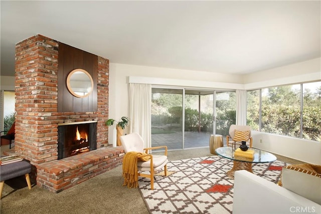 living area with light carpet and a fireplace