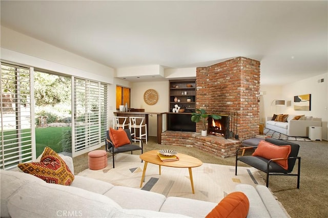 living room featuring light carpet and a brick fireplace