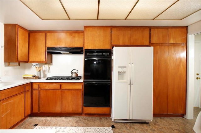 kitchen with dobule oven black, brown cabinets, extractor fan, light countertops, and white fridge with ice dispenser