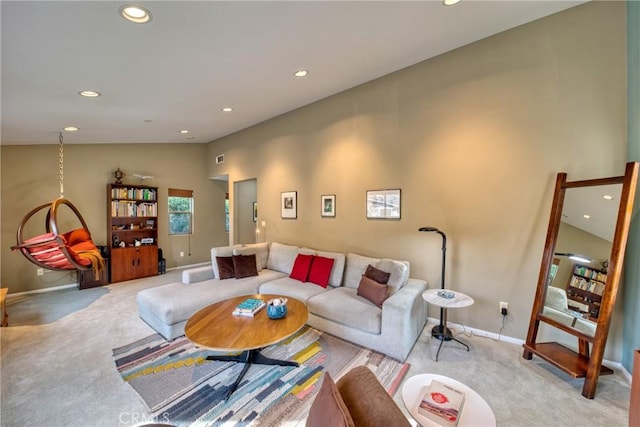 living area featuring vaulted ceiling, recessed lighting, baseboards, and light colored carpet