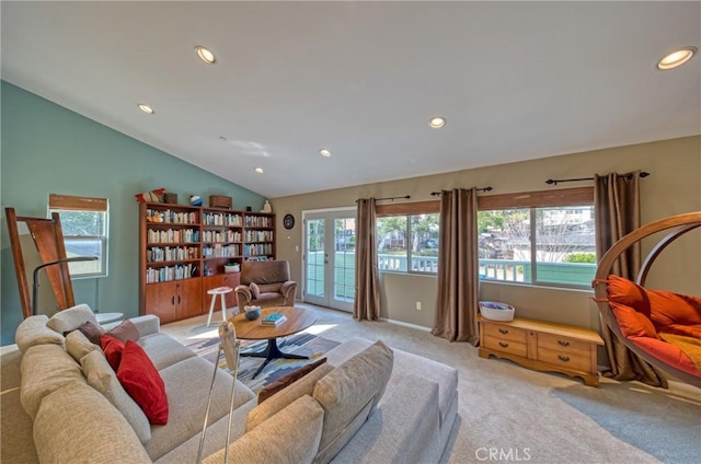 living room with vaulted ceiling, french doors, recessed lighting, and light colored carpet