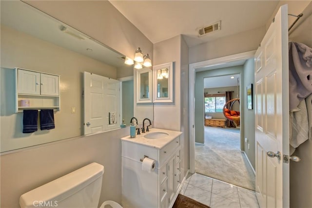 bathroom with visible vents, vanity, and toilet