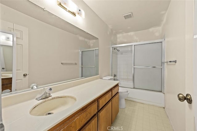 full bath with toilet, combined bath / shower with glass door, vanity, and visible vents