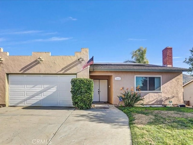 single story home featuring a garage, driveway, and stucco siding