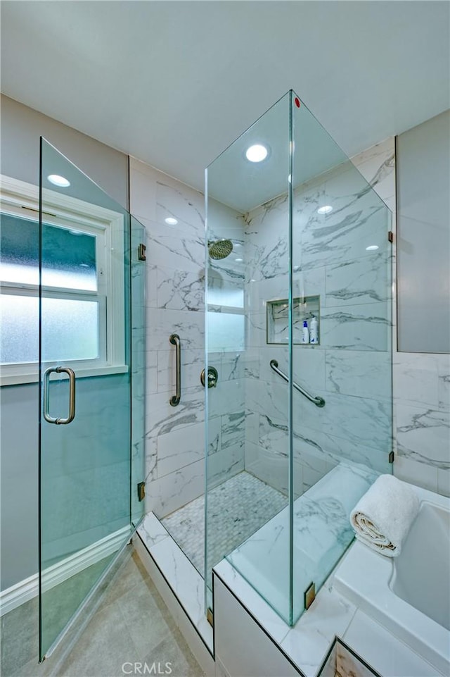 full bathroom with a marble finish shower and a washtub