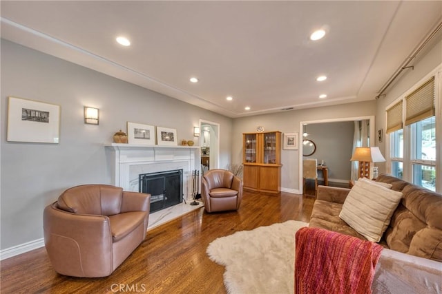 living area with dark wood-style floors, recessed lighting, a fireplace, and baseboards