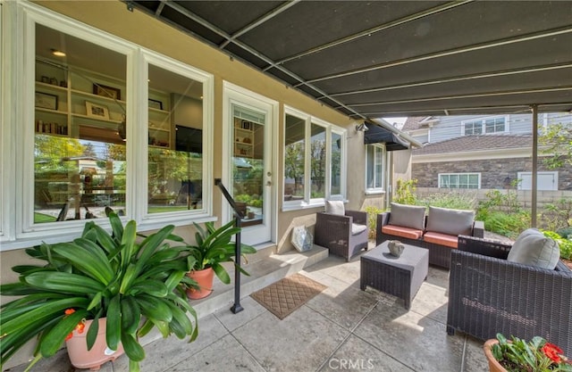 view of patio / terrace featuring outdoor lounge area and fence