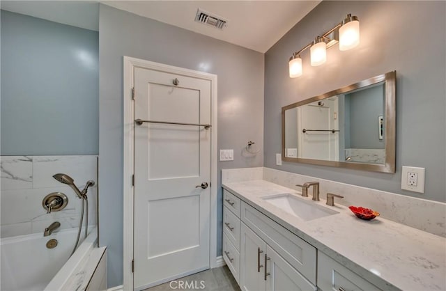 bathroom featuring washtub / shower combination, visible vents, and vanity