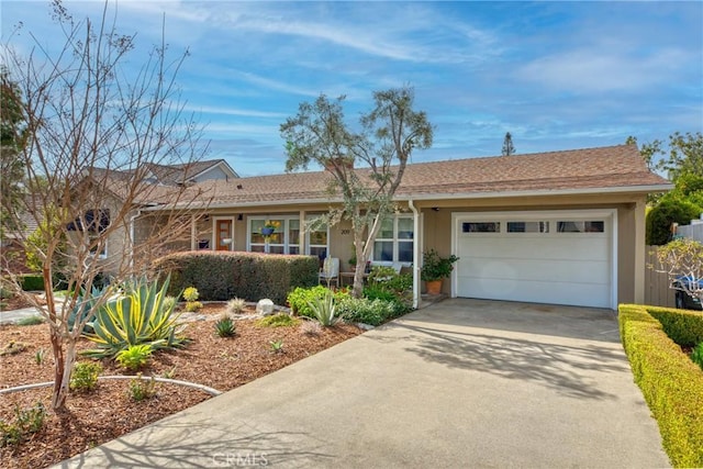 ranch-style home featuring a garage and concrete driveway