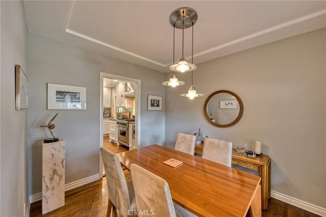 dining room featuring dark wood-style floors and baseboards