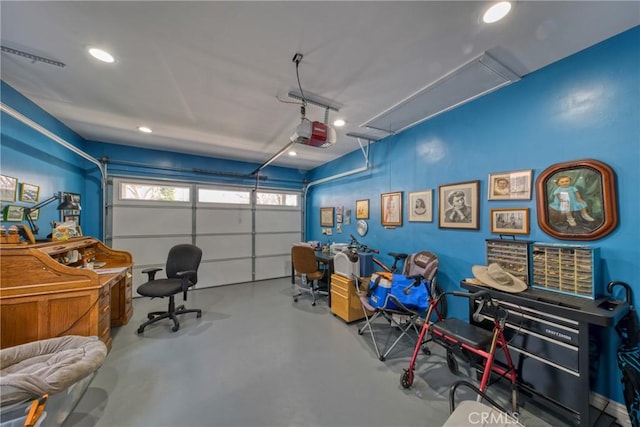 garage with a garage door opener and recessed lighting