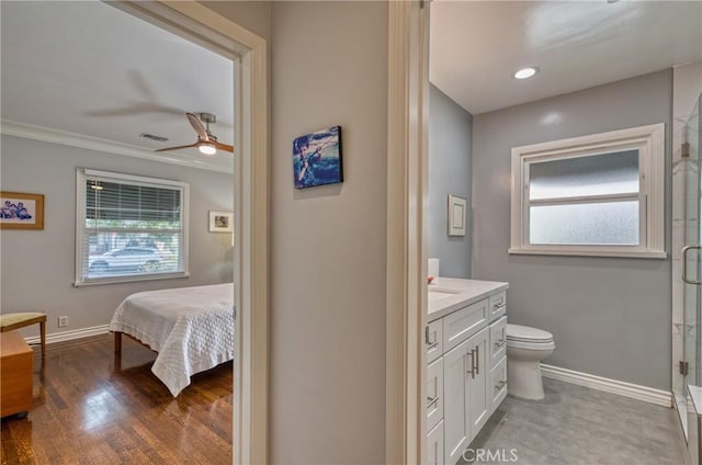 ensuite bathroom with visible vents, a stall shower, connected bathroom, vanity, and baseboards