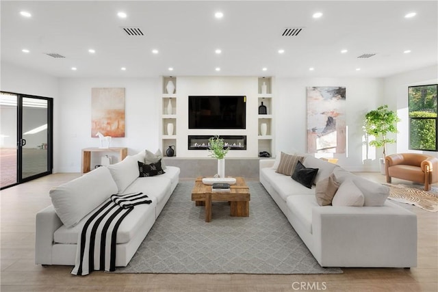 living area featuring visible vents and recessed lighting