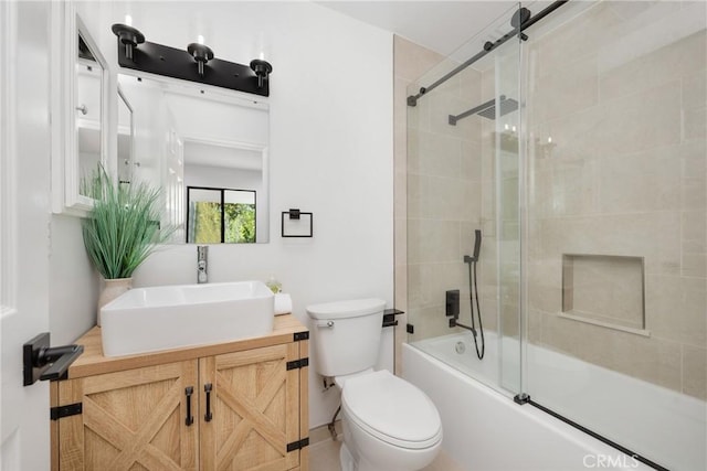 full bath featuring shower / bath combination with glass door, vanity, and toilet