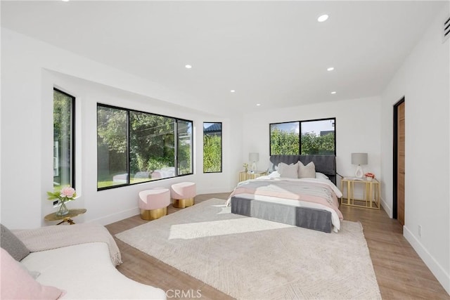 bedroom featuring light wood-style floors, recessed lighting, and baseboards