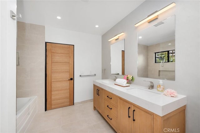 bathroom featuring recessed lighting, a sink, a bath, and double vanity