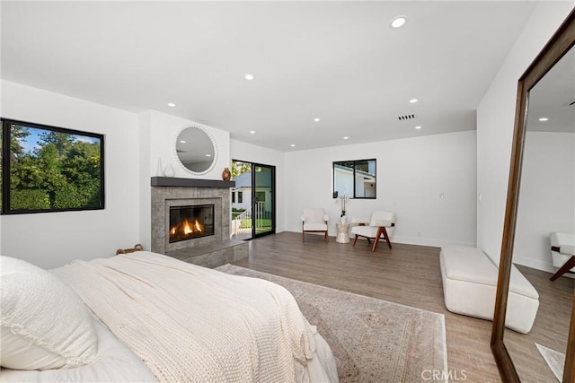 bedroom featuring multiple windows, wood finished floors, and recessed lighting