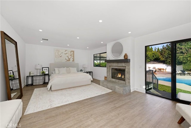 bedroom with baseboards, access to outside, light wood-type flooring, and recessed lighting