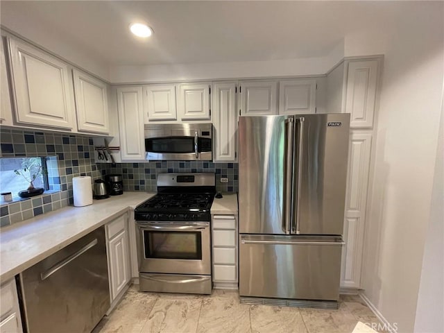 kitchen featuring appliances with stainless steel finishes, light countertops, decorative backsplash, and recessed lighting