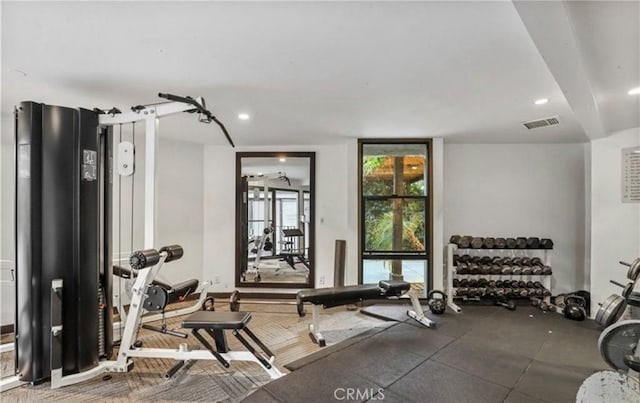 exercise room featuring recessed lighting, floor to ceiling windows, and visible vents