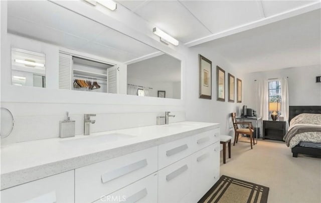 full bath featuring double vanity, ensuite bath, and a sink