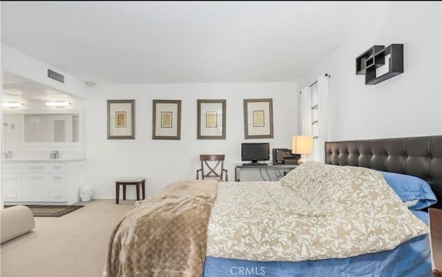 carpeted bedroom featuring visible vents