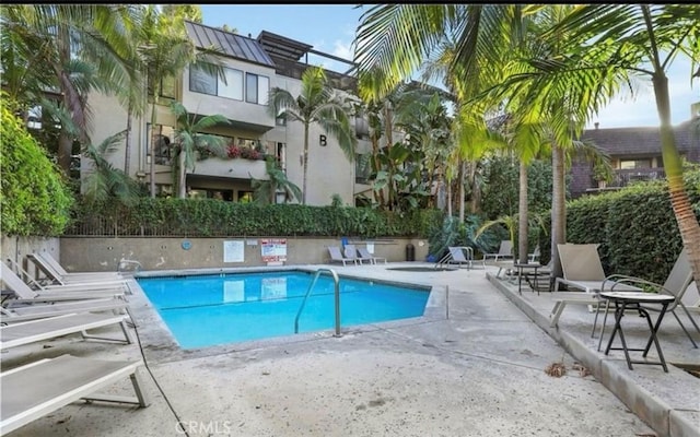 community pool with a patio area