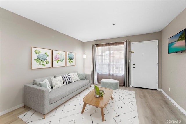 living area with wood finished floors and baseboards