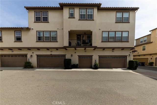 view of front facade with an attached garage and stucco siding