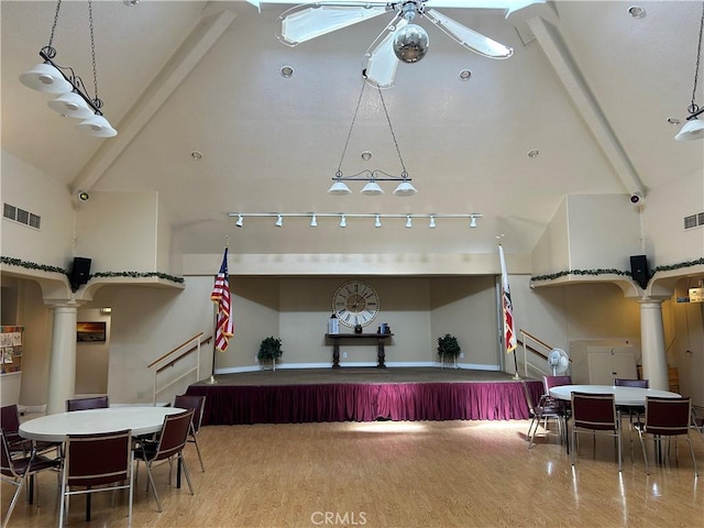playroom with arched walkways, high vaulted ceiling, decorative columns, and visible vents