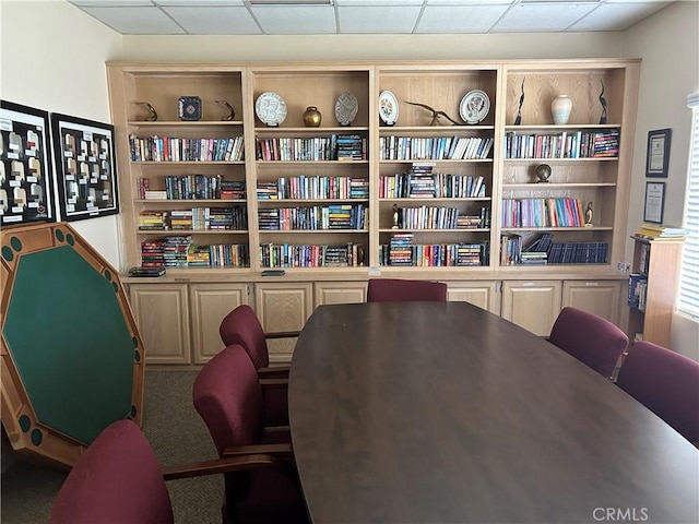 interior space with carpet floors and a drop ceiling