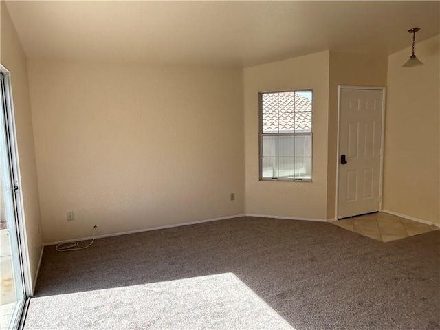 spare room featuring baseboards and light colored carpet