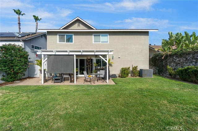 rear view of property with stucco siding, a patio, a pergola, and a yard